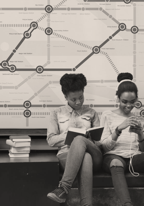 Girls sitting at a bus station